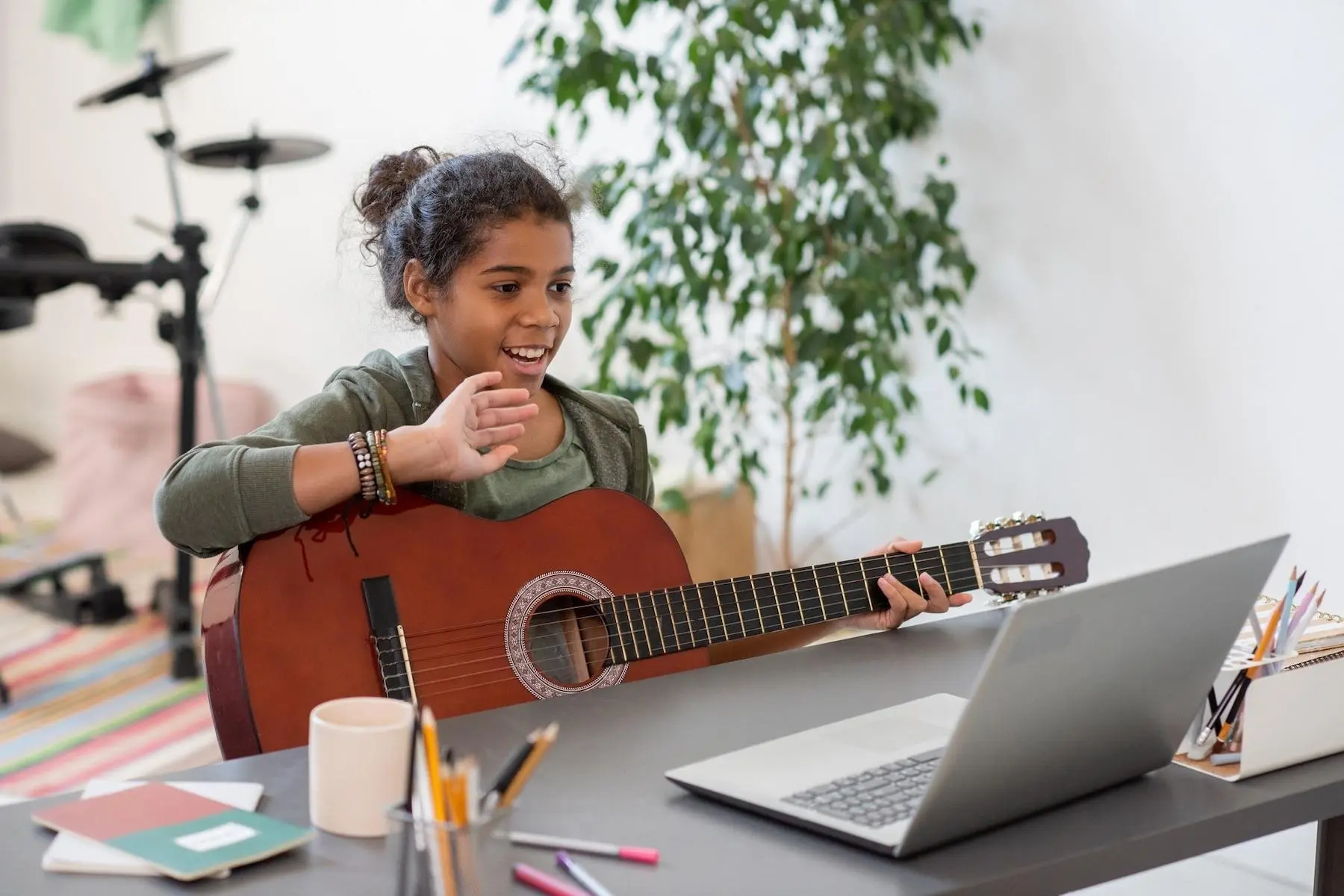 A kid learning guitar