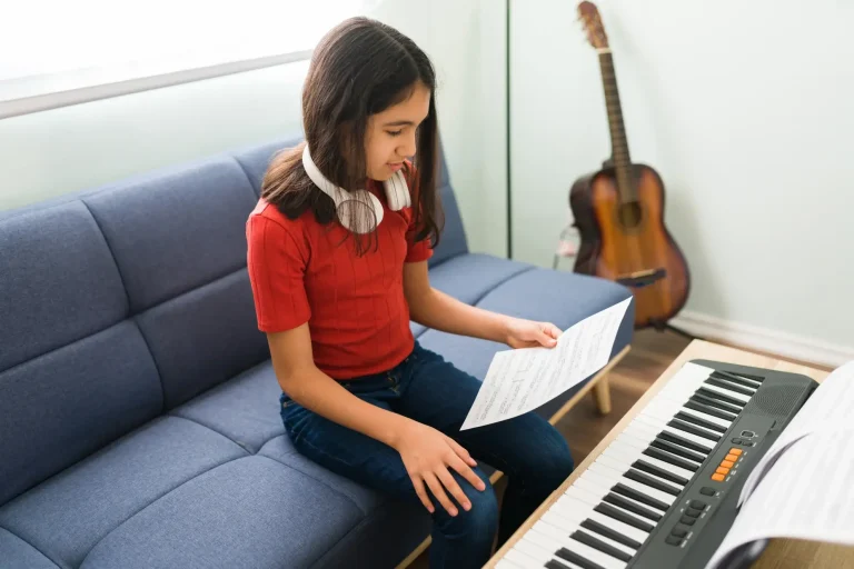Girl Playing keyboard While Learning Sheet Music