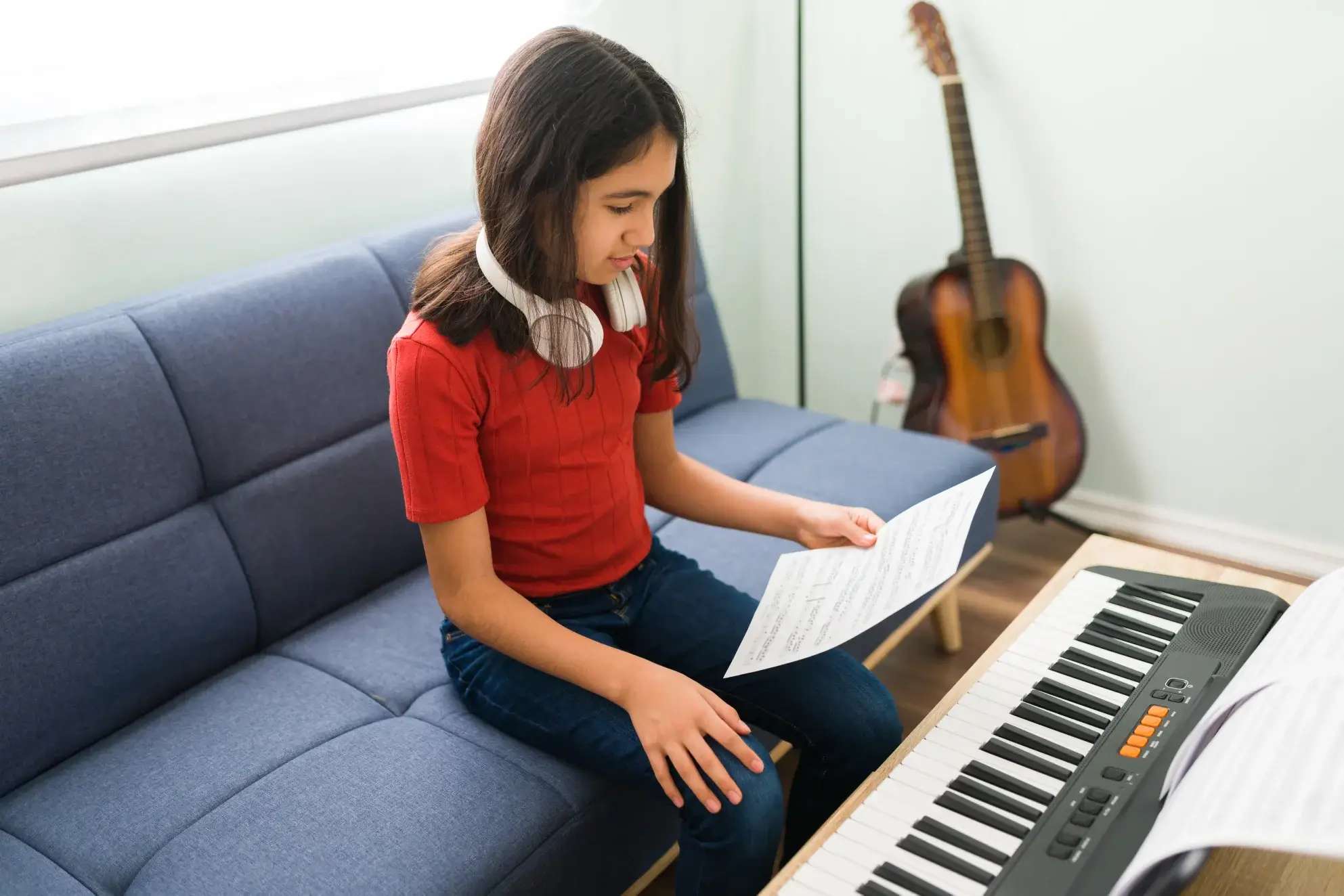 Girl Playing keyboard While Learning Sheet Music