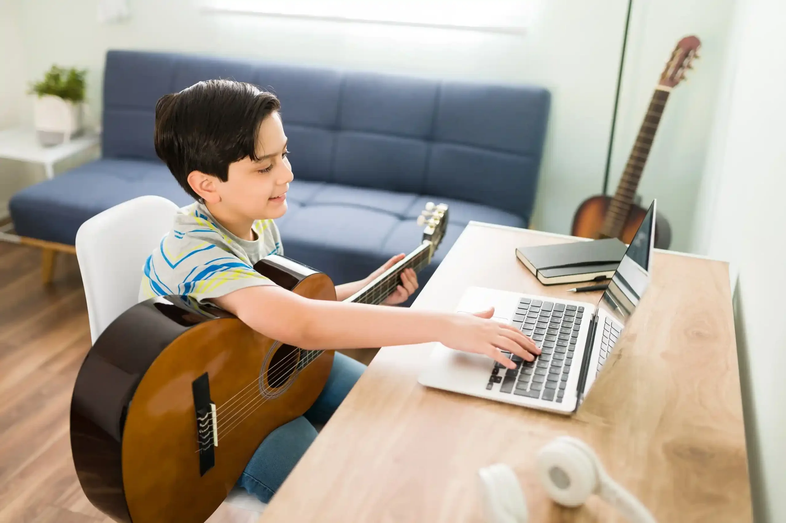 A boy learning guitar